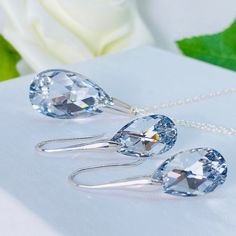 Elevate your style with our stunning set of silver jewellery featuring Comet Argent Light Crystals. This exquisite set includes a pair of earrings with a 32-millimetre drop and a necklace measuring 45 centimetres in length. Each piece is meticulously crafted from high-quality sterling silver, and adorned with mesmerizing Comet Argent Light Crystals that radiate a dazzling sparkle. The earrings and necklace are designed to catch the light from every angle, adding a touch of glamour to any outfit. Whether you're dressing up for a special occasion or looking for everyday elegance, this set is perfect for adding a touch of sophistication to your style. The unique design and shimmering crystals make this set a statement piece in your jewellery collection. Indulge in the beauty and sparkle of ou Silver Crystal Jewelry Set As Gift, Silver Crystal Jewelry Set For Gift, Classic Silver Jewelry Sets For Gift, Crystal Teardrop Pendant Jewelry Sets As Gifts, Silver Sterling Silver Jewelry Sets For Anniversary, Gift Crystal Teardrop Pendant Jewelry Sets, Classic Sterling Silver Jewelry Sets For Gift, Crystal Drop Jewelry Sets For Gift, Gift Crystal Drop Jewelry Sets