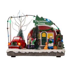 an outdoor christmas scene with cars and trees