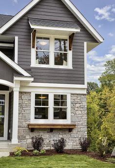 a gray house with white trim and windows