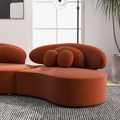 an orange couch sitting on top of a rug