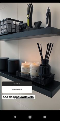 some candles are sitting on the shelf next to other items