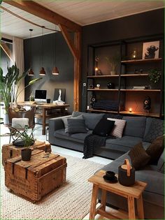 a living room filled with furniture next to a wooden table and bookshelf on the wall