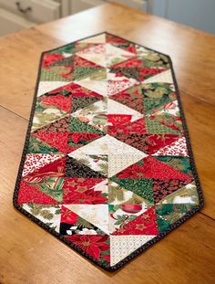 a patchwork table runner on a wooden table