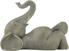 an elephant statue laying down on its back