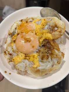 an egg is on top of rice in a bowl