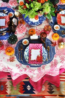 the table is set with plates and place settings