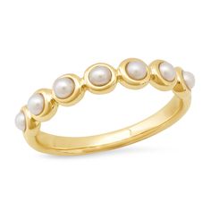 a gold ring with pearls on it