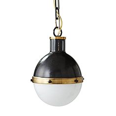 a black and white light hanging from a metal chain on a white background with gold accents