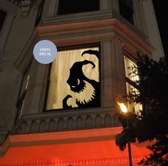 an image of a building with a clock on it's face at night time