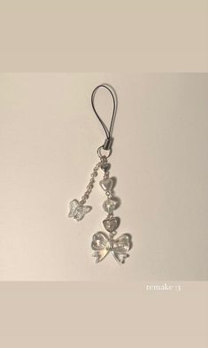 a keychain with some charms hanging from it's side on a white surface