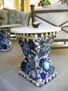 two blue and white vases sitting next to each other on top of a tile floor