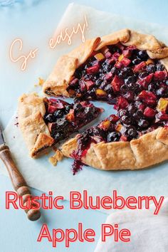 a blueberry apple pie is cut in half and ready to be eaten with the words rustic blueberry apple pie on it