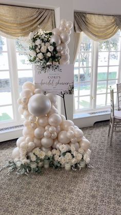 balloons and flowers are arranged in the shape of a tree