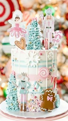 a three tiered cake decorated with christmas decorations and candy canes on a plate