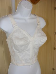 HERE WE HAVE A DEADSTOCK LONG LINE BRA FROM THE 1960S BY PLAYTEX THE BRA IS ELASTIC MESH BODY WITH SIDE STAYS AND NYLON LACE CUPS AND BODICE WITH A COTTON LINING . THE BRA HAS WIDE ADJUSTABLE STRAPS AND A WIDE ELASTIC BAND AROUND BACK WITH 2 SETS OF HOOK AND EYES THAT ARE AN INCH APART .  THERE IS A NARROW ELASTIC BETWEEN CUPS / ADJUSTABLE STRAPS MEASUREMENTS WERE TAKEN ACROSS AND DOUBLED , LAID FLAT , UNSTRETCHED : B cup/ 34" bust / 24'"band size/ 15" from shoulder to hem  THANK YOU FOR LOOKING AT MY LISTING  I AM ALWAYS HAPPY TO ANSWER QUESTIONS AND INQUIRIES Long Line Bra, Bra Items, Bullet Bra, Longline Bra, B Cup, Underwire Bra, Bra Lingerie, Elastic Band, Stretch Cotton