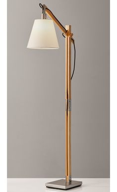 a wooden lamp with a white shade on it's head and a metal base