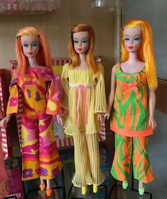 three dolls are standing next to each other