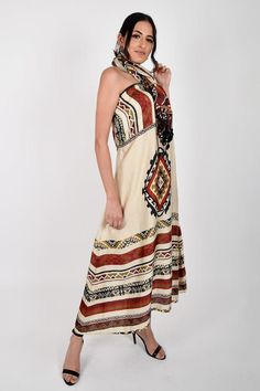 Rust, multi colored placement print tube dress with geometric patterns. Comes with a stole. 
Components: 2
Pattern: Print
Type Of Work: Geometric
Neckline: Straight
Sleeve Type: Sleeveless
Fabric: Crepe
Color: Maroon
Other Details: 
Tasseled stole
Occasion: Resort - Aza Fashions Bohemian Sleeveless Midi Dress In Multicolor Print, Bohemian Sleeveless Multicolor Midi Dress, Multicolor Bohemian Printed Sleeveless Dress, Multicolor Bohemian Midi Sleeveless Dress, Multicolor Bohemian Sleeveless Midi Dress, Bohemian Multicolor Sleeveless Midi Dress, Multicolor Halter Neck Dress With Boho Print, Bohemian Multicolor Printed Sleeveless Dress, Patterned Sleeveless Bohemian Midi Dress