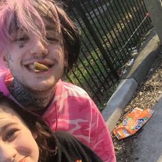 two young people with pink hair and piercings