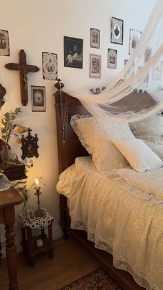 a bed with white bedspread and lots of pictures on the wall