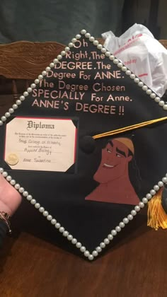 a decorated graduation cap with an image of the character pocahonna on it