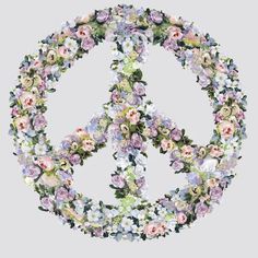 a peace sign made out of flowers on a gray background