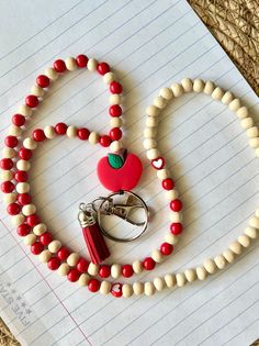 Red colored lanyard with wooden and plastic beads designed to go over head with ease. Includes a tassel. This lanyard goes great for keys, or identification card. Optional Identification sleeve available for purchase. Homemade Lanyards Diy, School Lanyard, Lanyard Ideas, Acrylic Nails Almond Shape, Diy Lanyard, Lanyard Teacher, Diy Key, Future Job, Lanyard Necklace