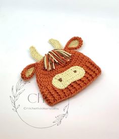 an orange crocheted cow hat with horns