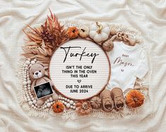 a baby's first thanksgiving card surrounded by pumpkins, leaves and other items