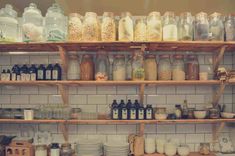 shelves filled with lots of different types of jars and containers on top of each other