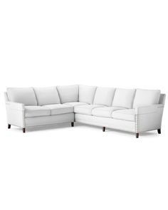 a white sectional couch sitting on top of a white floor