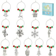 wine glass charms with christmas decorations hanging from the bottom, and an ornament attached to them