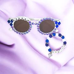 Diamonds are a girls best friend! Rarity from My Little Pony inspired girls sunglasses and bracelet! If your little one loves My Little Pony, these will be the most adorable and perfect gift! They also make a fun and special My Little Pony themed party favor. White round sunglasses with name on it are adorned with 6mm purple rhinestones and three blue diamond shaped gems on each side to match Rarity's cutie mark! Bracelet is 8mm acrylic beads alternating between purple, white, and blue with rhin Pony Party Favors, Clear Plastic Bags, My Little Pony Party, Pony Party, Girl With Sunglasses, Purple Rhinestone, Rarity, Character Costumes, Blue Diamond