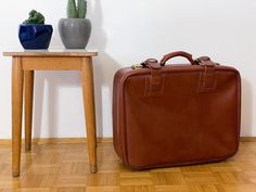 Large cognac brown vintage faux leather suitcase made in the 70s, Yugoslavia. It comes with a handle, two straps with gold metal buckles and two gold metal side locks. This lovely vintage suitcase would make great storage for toys, blankets or books. It could also still be used as a travelling suitcase or, props for a wedding or photography. Condition: Mint vintage condition with almost no signs of use. Thanks for stopping by! Vintage Brown Luggage For Everyday Use, Vintage Brown Luggage For Trips, Vintage Brown Rectangular Luggage, Vintage Brown Leather Luggage, Brown Travel Bags, Vintage Cognac Briefcase For Travel, Retro Brown Briefcase For Travel, Retro Brown Travel Briefcase, Retro Brown Briefcase