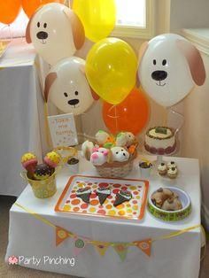 a table topped with lots of balloons and cakes