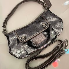 Coach Poppy Limited Edition Silver Sequin Groovy Crossbody Bag #15381 - Style: Crossbody/Satchel - Material: Graphite Grey Silver Sequins With Leather Trim Silver Hardware - Closure: Zip-Top - Inside Zip And Multifunction Pockets - Exterior Front Pocket Kept Closed With Hidden Magnetic Snap - Fabric Lining. - Approx. 11" (L) X 6.75" (H) X 4" (W) - 100% Authentic New Without Tags Elegant Coach Shoulder Bag For Party, Chic Coach Party Bag, Luxury Coach Bag For Party, Luxury Coach Party Bag, Luxury Coach Party Bags, Chic Party Bags By Coach, Coach Evening Crossbody Bag, Crossbody Satchel, Coach Poppy