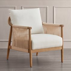 a wooden chair with a white pillow on it's back and armrests