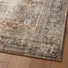 an area rug on the floor with a wooden floor and wood floors in front of it