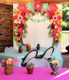 the table is decorated with flowers and pineapples