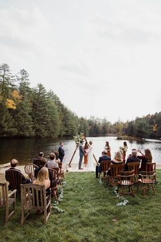 a couple getting married in front of a lake