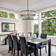 a dining room table with chairs and a chandelier