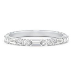 a white gold wedding band with baguets and diamonds on the side, set in 18k white gold