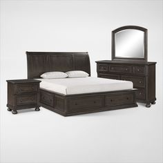 a bedroom with a bed, dresser and mirror