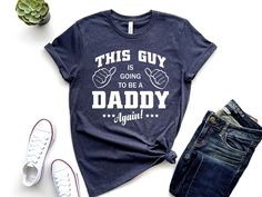 Baby Announcement Shirt for New Dad, This Guy Is Going To Be Daddy Again, Daddy To Be Shirt, New Father Tee, Gift for New Dad, Promoted To Daddy Take a seat and pick the most ideal pregnancy announcement shirts to make this season the most memorable one yet. Funny Pregnancy announcement shirts provide a fun and creative way to share the good news with friends and family. There is nothing quite as exciting as figuring out a novel way to let them know what's cooking ❀ FABRICS ❀ 1-100% Combed and R Cute Ways To Announce Pregnancy To Daddy, Daddy To Be T Shirt, Cute T-shirt For Father's Day Gender Reveal, Mom And Dad Shirts Pregnancy, Cheap Bump Friendly T-shirt For Pregnancy Announcement, Baby Announcement Shirt, Gift For New Dad, New Father, Funny Pregnancy Announcement