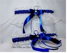 the bridal garter is adorned with blue satin ribbons and jeweled heart brooches