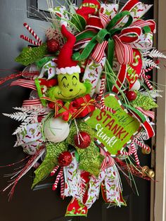 the grinch wreath is hanging on the front door