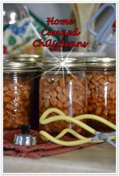 three jars filled with nuts sitting on top of a table next to a pair of scissors