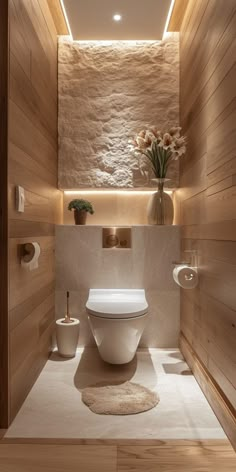 a modern bathroom with wood paneling and white toilet in the center, surrounded by wooden walls