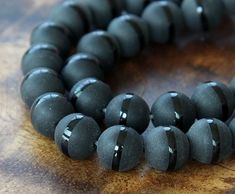 Black Agate Beads with a Stripe, Matte, 10mm Round These agate beads are dyed in a deep black color and feature a matte surface with a shiny stripe running around the bead. Chakra Beads, Beads For Sale, Indian Agate, Large Hole Beads, African Jewelry, Black Agate, Holiday Jewelry, Crazy Lace Agate, Deep Black