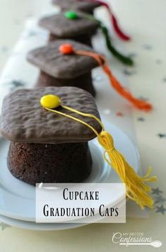 graduation cap cake on a plate with the words cupcake graduation caps in front of it